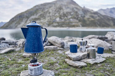Coffee pot on gas stove burner by lake, Splugen Pass, Sondrio, Italy - SSCF00856