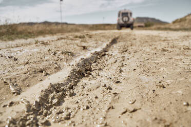 Wet tire track on muddy road - SSCF00907