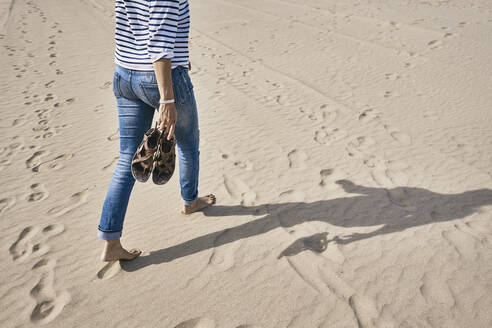Tourist mit Schuhen auf Sand am Strand - SSCF01009