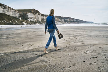 Tourist walking on sand at beach - SSCF01053