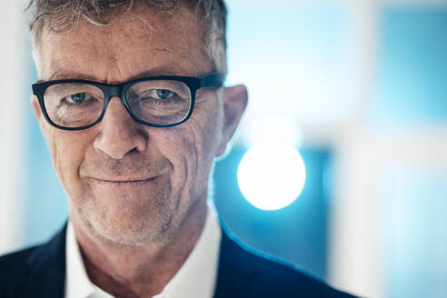 Portrait of smiling businessman with eyeglasses - JOSEF07277