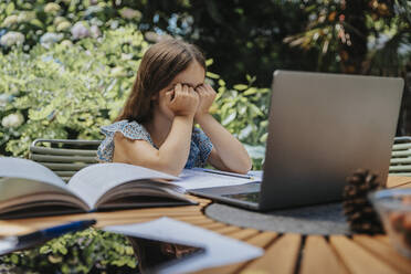 Overwhelmed girl with laptop at online education - MFF08593