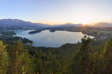 View of Lake Faak at sunset with Karawanks mountains in background - RUEF03525