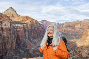 Smiling woman by canyon at Zion National Park in Utah, USA - TETF00173
