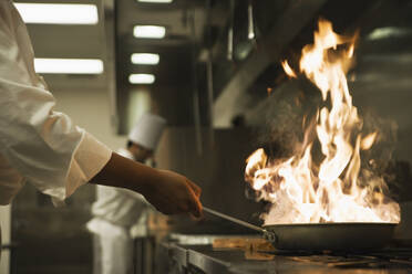 Chef holding flaming pan - TETF00250