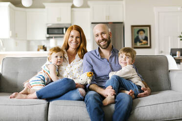 Family smiling on sofa - TETF00325