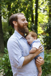 Father holding baby son, outdoors - TETF00340