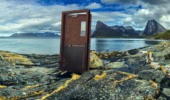 Mysterious door standing on rocky shore of Senja island - VTF00659