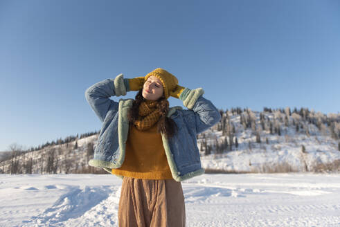 Woman with eyes closed on sunny day at forest - VBUF00028