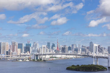 Japan, Kanto Region, Tokyo, Rainbow Bridge with downtown skyline in background - FOF12923
