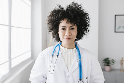Doctor with curly hair at medical clinic - XLGF02787