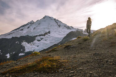 Female In Tights Standing In Front Of Mount Baker In The Cascades - CAVF95626