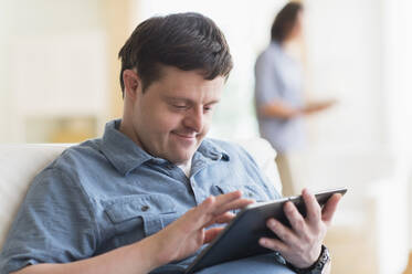 Man with down syndrome using tablet - TETF00447