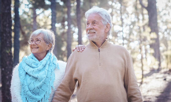 Smiling senior couple enjoying in forest - SIPF02778