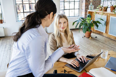 Businesswomen discussing at home office - DMOF00261