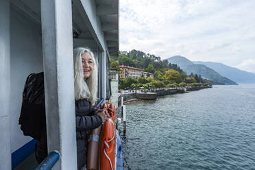 Ältere Frau lächelnd auf Fähre am Comer See, Italien - TETF00558