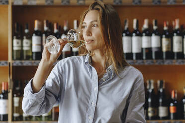 Junge Frau trinkt ein Glas Weißwein - TETF00696