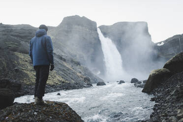 Hiker by Haifoss waterfall in Iceland - TETF00732