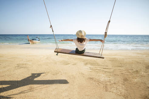 Young woman on swing at beach - TETF00736