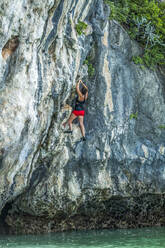 Woman rock climbing in Phuket, Thailand - TETF00959