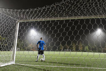 USA, Kalifornien, Ladera Ranch, Torwart auf beleuchtetem Fußballfeld bei Nacht - TETF01005