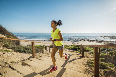 Spain, Aviles, young athlete woman running along a coastal path - a Royalty  Free Stock Photo from Photocase