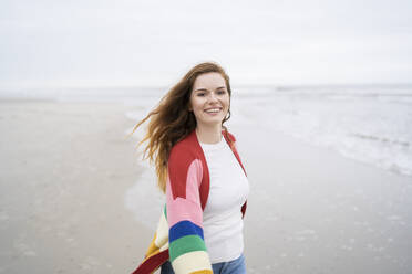 Happy woman with long hair enjoying at beach - AKLF00562