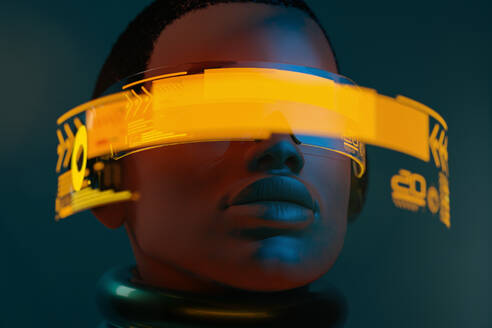 Portrait of black woman wearing augmented virtual reality goggles in metaverse - ADSF33934