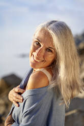 Happy mature woman with gray hair enjoying sunny day - VEGF05391