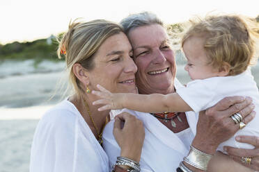 Three generations of Caucasian family on beach - TETF01346