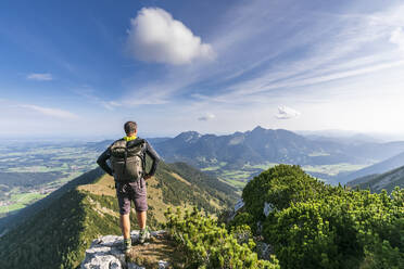 Male hiker admiring view from summit of Aiplspitz mountain - FOF12973