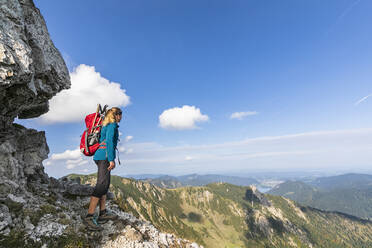 Female hiker admiring view from summit of Aiplspitz mountain - FOF12974