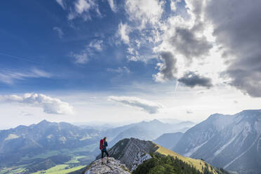 Female hiker admiring view from summit of Aiplspitz mountain - FOF12977