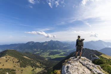 Male hiker admiring view from summit of Aiplspitz mountain - FOF12979