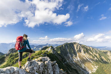 Female hiker admiring view from summit of Aiplspitz mountain - FOF12985