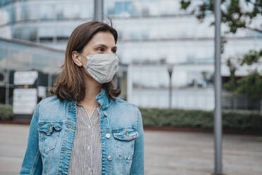 Woman in denim jacket wearing protective face mask - MFF08916