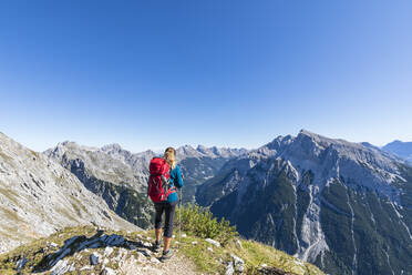 Wanderin bewundert die Aussicht auf den Mittenwalder Hohenweg im Sommer - FOF13019