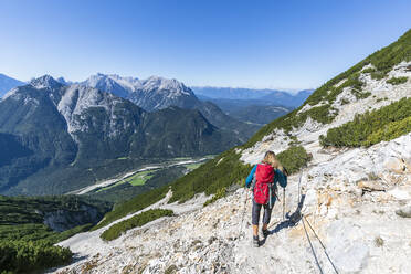 Female hiker descending Brunnensteinspitze mountain in summer - FOF13024