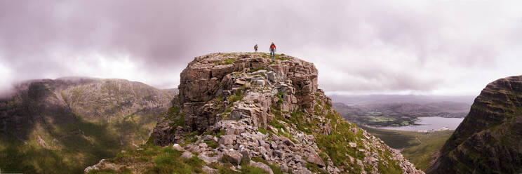 Mountain climbers standing on top of rocky mountain - ALRF01849