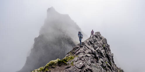 Man and woman walking on mountain cliff - ALRF01855