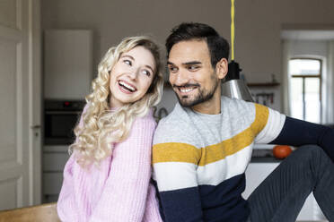 Blond woman sitting with boyfriend at home - PESF03572
