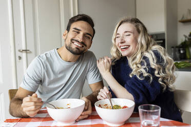 Happy couple enjoying meal at home - PESF03596