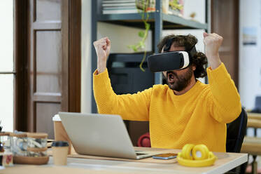 Businessman with mouth open wearing virtual reality simulator in office - KIJF04398