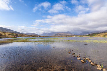 Scenic view of Loch dam with mountains in background under cloudy sky - SMAF02125