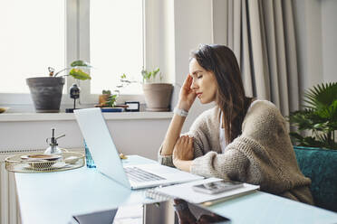 Freelancer with eyes closed sitting at desk - BSZF01998