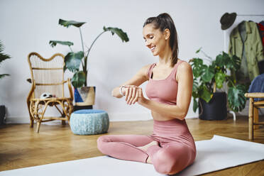 Sporty woman sitting in a yoga studio with her class stock photo (267087) -  YouWorkForThem