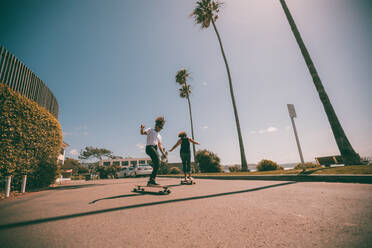 Weibliche Skateboarder skaten auf einer Promenade - CAVF95817