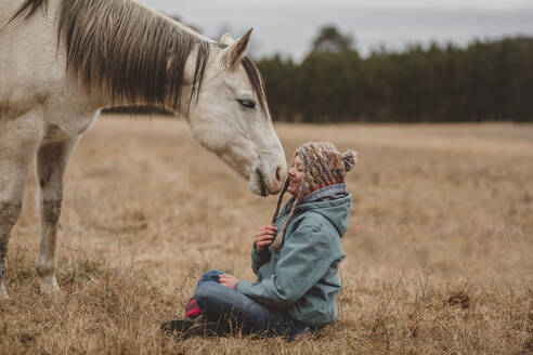 Happy teen girl in front of horse - CAVF95843