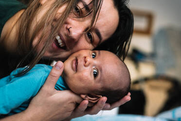 Portrait of a young woman smiling with her baby. - CAVF95899