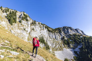 Female hiker admiring landscape of Bavarian Prealps - FOF13040